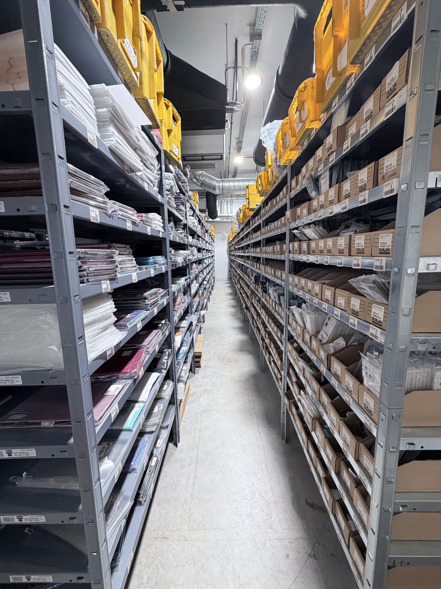 Wigento GmbH warehouse aisle with shelves and packaging